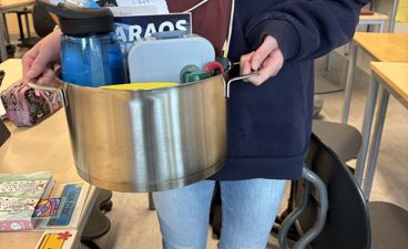 en person som holder en metallbøtte