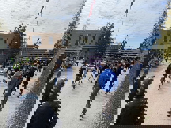 en gruppe mennesker som går rundt en bygning